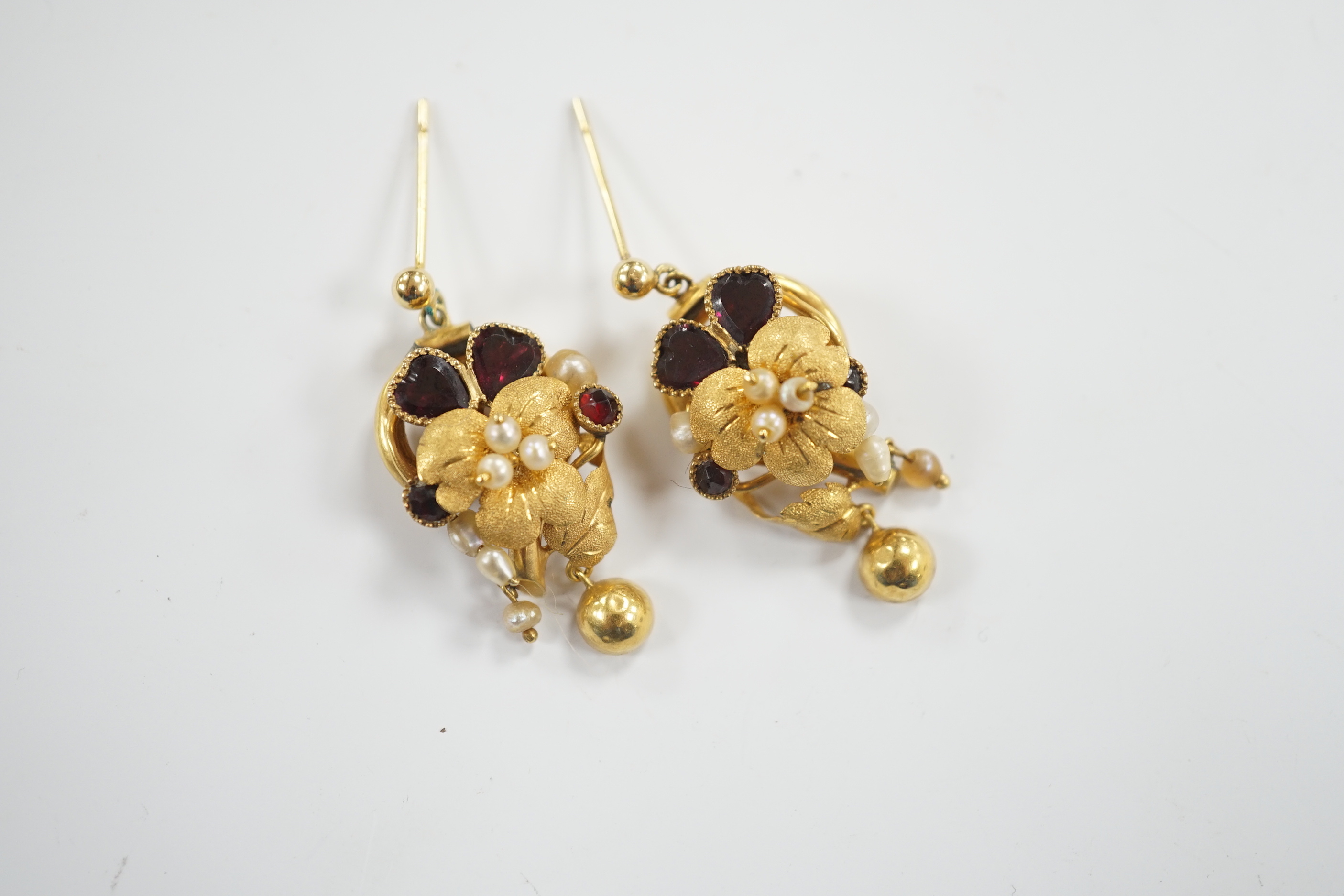 A pair of Victorian yellow metal, garnet and pearl set drop earrings, of foliate form, 31mm (adapted?), gross weight 6.8 grams.